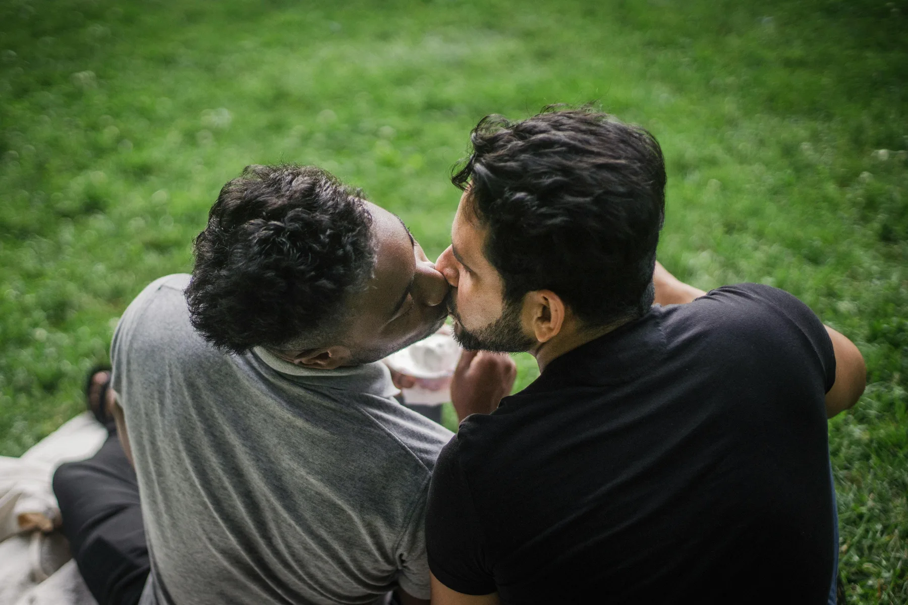 Two men relaxing on couch