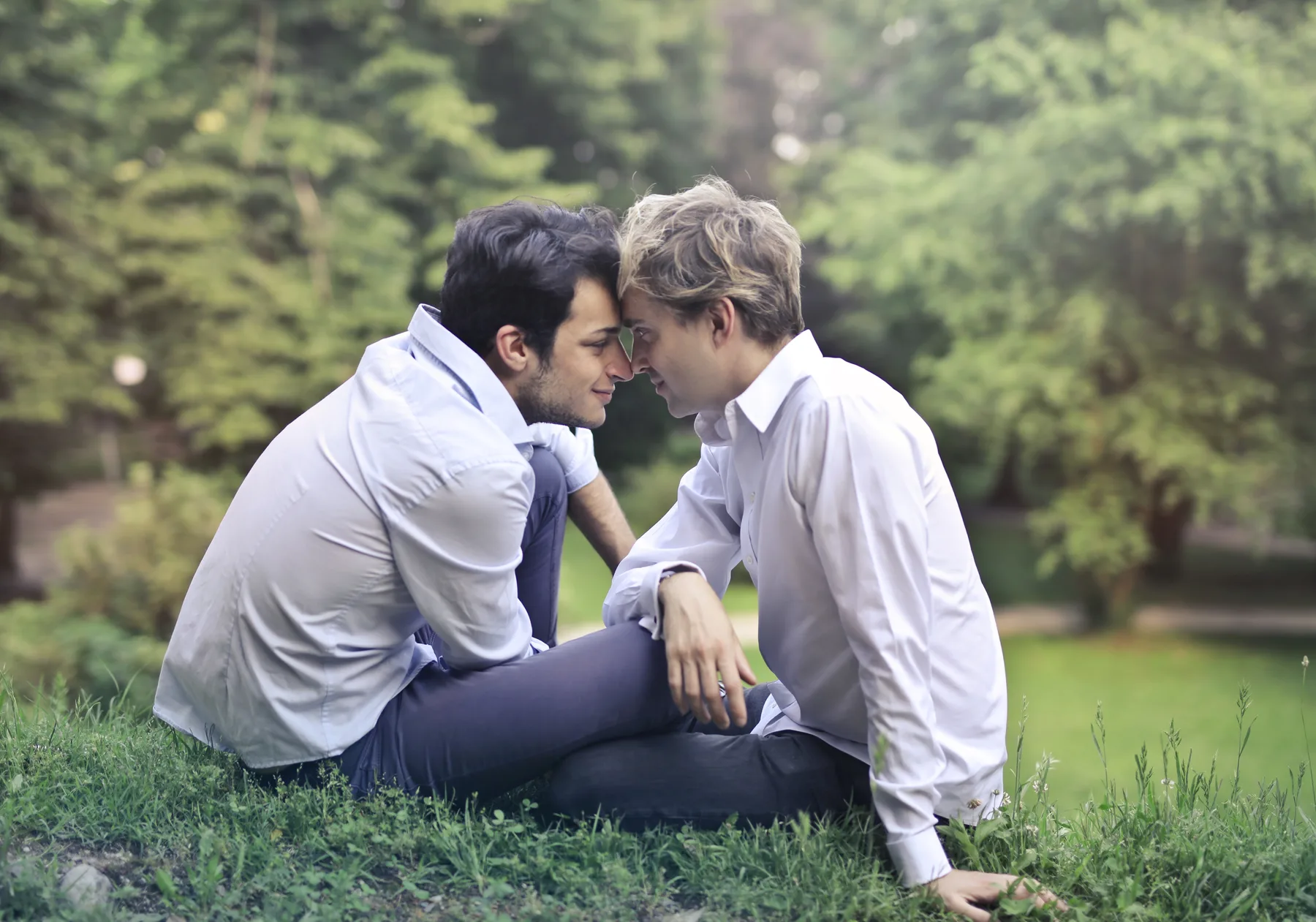 Two men in the same space holding emotional distance after a trust break.