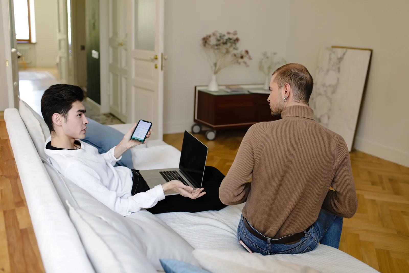 Two men sitting closely together and working through a difficult conversation.